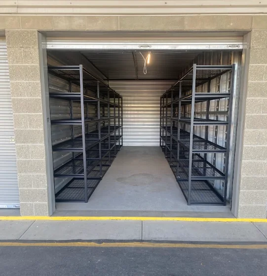 Metal shelving units installed in garage with concrete floor and roll-up door