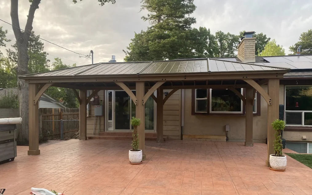 Timber frame covered patio with metal roof and brick paver deck
