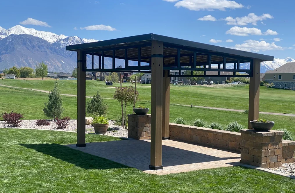 Dark wood pergola with paver patio, stone planters, and mountain views